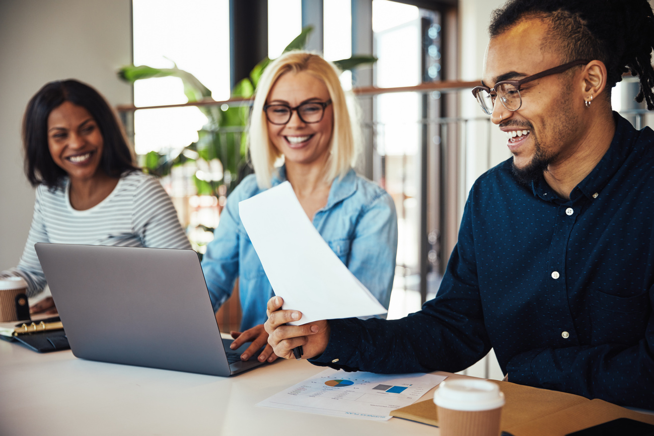 Smiling African American Office Worker Reading Paperwork during